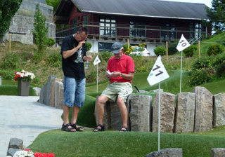 Men counting scores after playing adventure golf